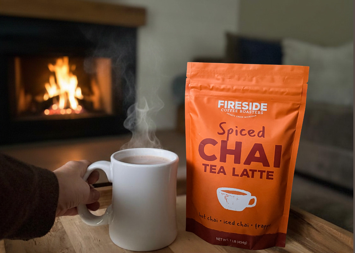 Fireside Spiced Chai Tea Latte bag beside a steaming mug in front of a fire