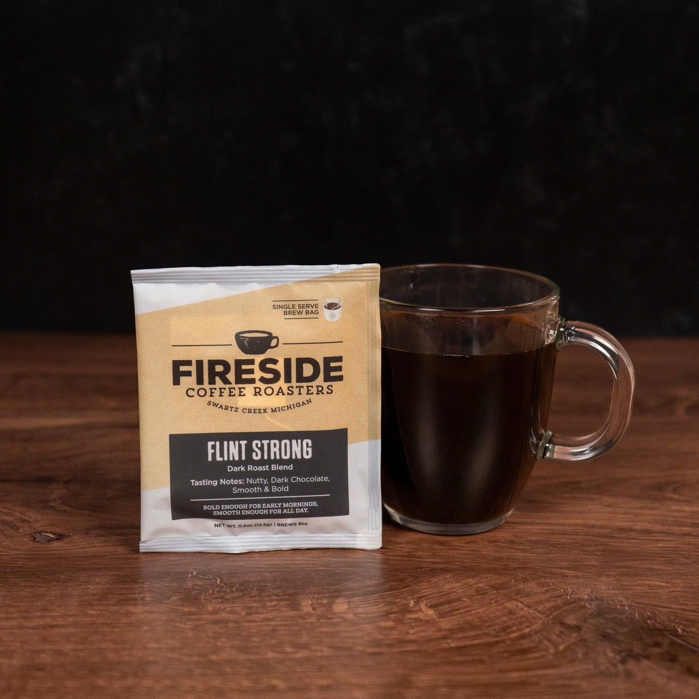 Fireside Coffee Roasters package with a glass mug of coffee on a wooden surface