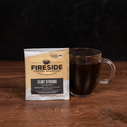 Fireside Coffee Roasters package with a glass mug of coffee on a wooden surface